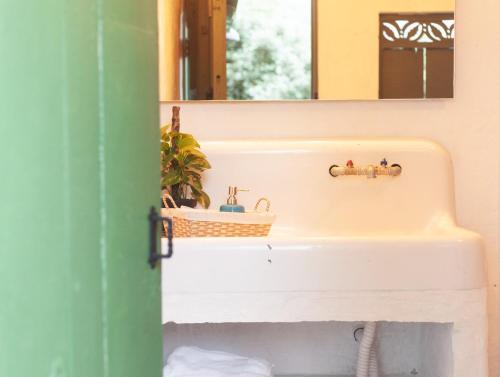 a bathroom with a sink and a mirror at La Liebre bed and breakfast in El Retiro