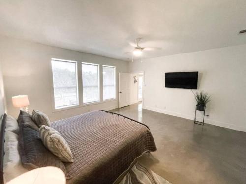 a bedroom with a bed and a flat screen tv at Lakeside Escape in McQueeney