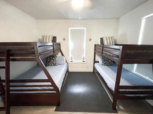 two bunk beds in a small room with a window at Lakeside Escape in McQueeney