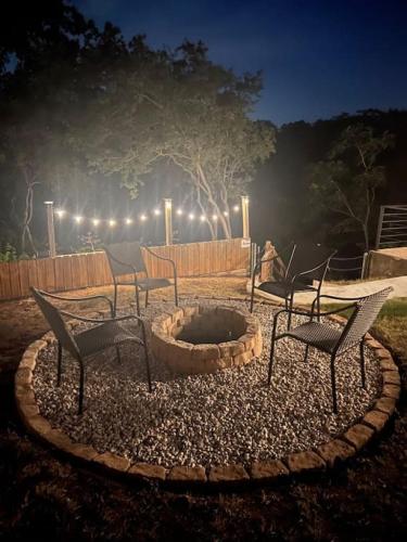 a patio with chairs and a fire pit at night at Lakeside Escape in McQueeney