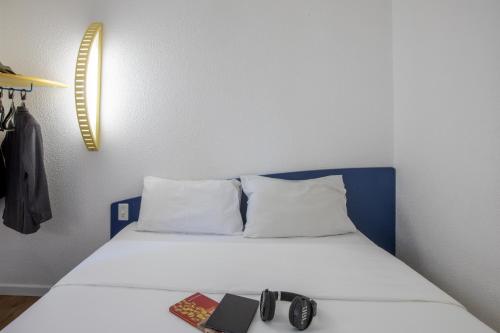 a bed in a room with two books on it at ibis budget Sao Paulo Morumbi in Sao Paulo