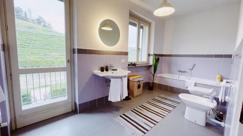 a bathroom with a sink and a toilet and a tub at Casa da Bertu in Barbaresco