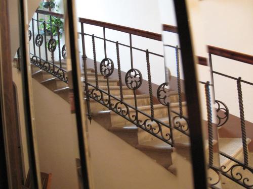 a staircase with wrought iron railings in a building at La Chicca B&B Siena in Siena