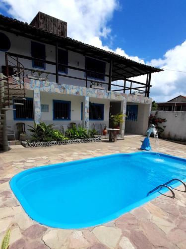 a swimming pool in front of a building at Ap 04-A 50 Metros da Praia Flats Mobiliados para 2 Pessoas in Paulista
