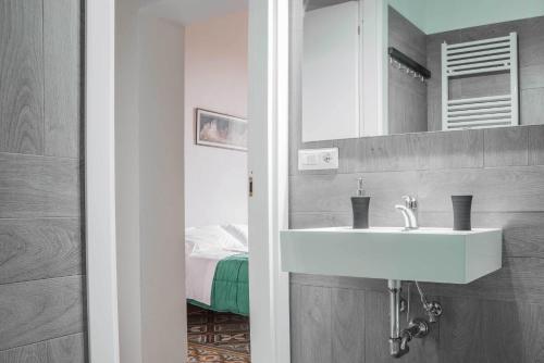 a bathroom with a sink and a mirror at La Chicca B&B Siena in Siena