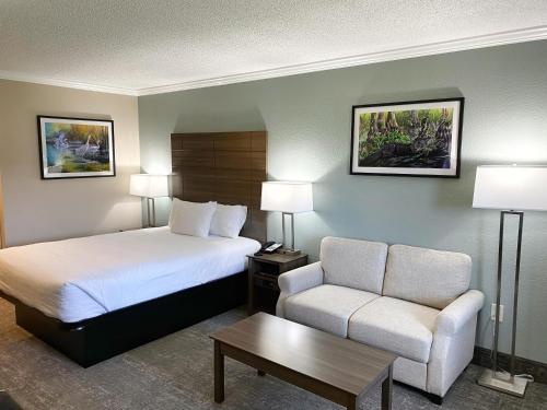 a hotel room with a bed and a chair at Roadstar Hotel Zephyrhills in Zephyrhills