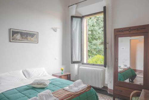 Ένα ή περισσότερα κρεβάτια σε δωμάτιο στο La Chicca B&B Siena