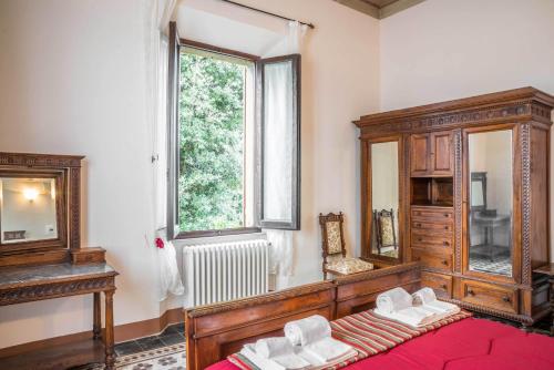 a bedroom with a bed and a large window at La Chicca B&B Siena in Siena