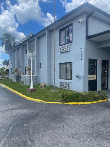 a white building on the side of a street at Ambassador Inn in Kissimmee