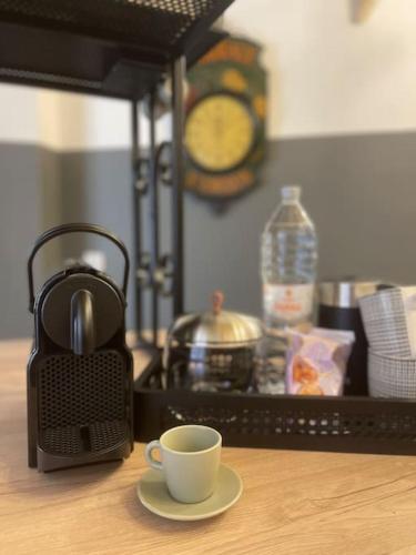 a coffee maker and a cup sitting on a table at 300yr old, self catering, tiny house in Victoria Centre, Gozo in Victoria