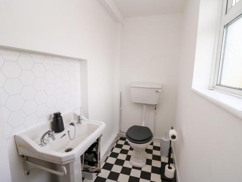 a bathroom with a black and white checkered floor at Ty Melyn in Aberystwyth