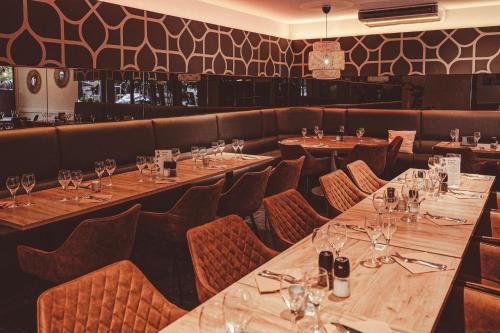 a dining room with wooden tables and chairs at Hotel La Caleche in Durbuy