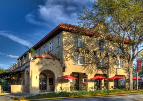 a building with red umbrellas in front of it at Artisan Downtown in DeLand