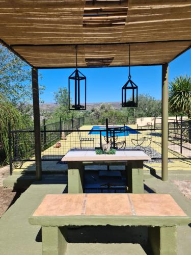 una mesa de picnic bajo una pérgola de madera con una mesa en Posada Trinidad in 