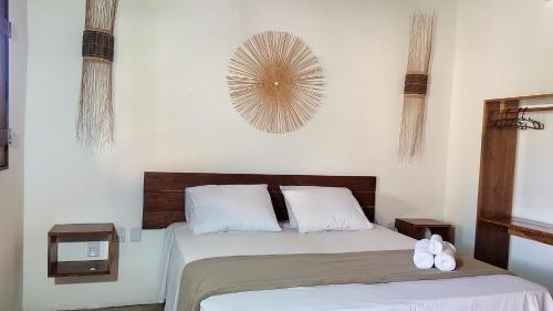 a bedroom with a bed with two white pillows at Reserva Rede e Mar - Rota dos Milagres - Patacho in Pôrto de Pedras