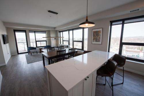a kitchen and dining room with a table and chairs at The Berkman in Rochester