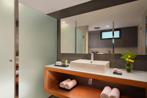 a bathroom with a sink and a mirror at Dreams Cozumel Cape Resort & Spa in Cozumel