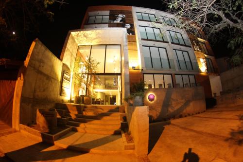 a building with stairs in front of it at night at Alfonsina Hotel Boutique in Santa Cruz de la Sierra