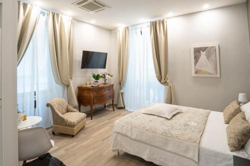 a bedroom with a bed and a chair and a desk at COVO DI LEVANTE in La Spezia