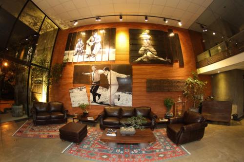 a lobby with leather couches and tables in a building at Alfonsina Hotel Boutique in Santa Cruz de la Sierra