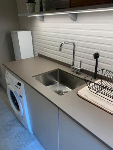 a kitchen with a sink and a washing machine at Macarena's House in Valldemossa