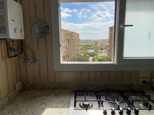 a window above a stove in a kitchen with a view at Luxury Inn 3BR Amazing view in Madinaty B2 in Madinaty