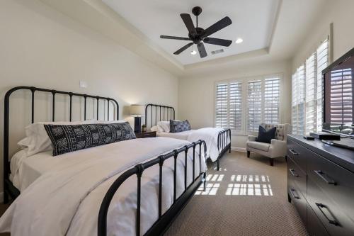 a bedroom with a large bed and a ceiling fan at Escape to Legends - Pool, Games & Amazing Mountain Views in PGA West #067651 5br in La Quinta