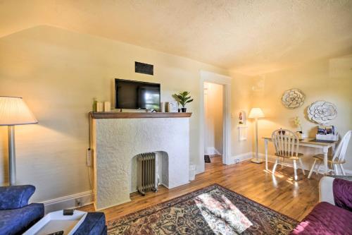 a living room with a fireplace with a tv above it at WFH-Friendly Billings Apt about 1 Mi to Downtown! in Billings