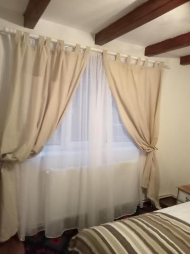 Кровать или кровати в номере Casuta din Deal