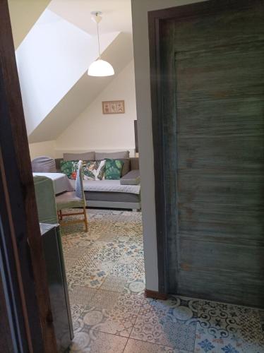a door leading into a living room with a couch at Ostoja Karkonoska in Podgórzyn