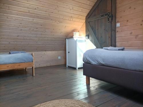 a room with two beds and a refrigerator at Ostoja Karkonoska in Podgórzyn