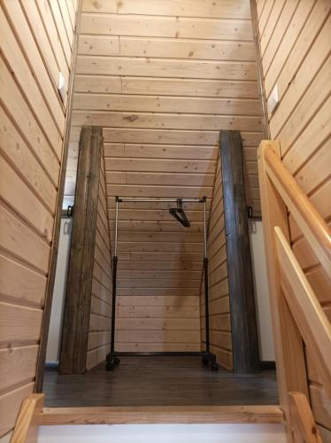a stairway leading to a room with wooden walls at Ostoja Karkonoska in Podgórzyn