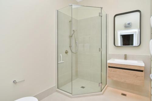 a glass shower in a bathroom with a sink at Kaiapoi Luxury Accommodation 1 - Bookahome in Kaiapoi