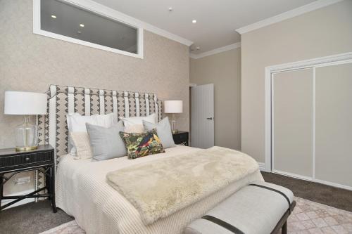 a bedroom with a large bed and a window at Kaiapoi Luxury Accommodation 1 - Bookahome in Kaiapoi