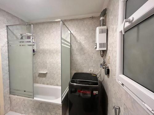 a bathroom with a shower and a trash can at Luxury Inn 3BR Amazing view in Madinaty B2 in Madinaty