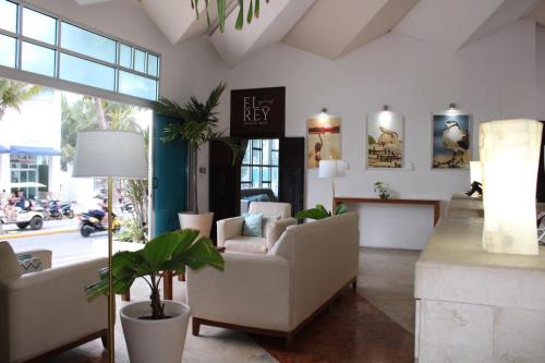 a lobby with a waiting room with couches and a table at Bahia Chac Chi - Adults Only in Isla Mujeres
