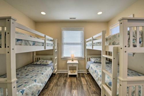 a bedroom with two bunk beds and a window at Wildwood Townhome with Patio 1 Block To The Beach! in Wildwood