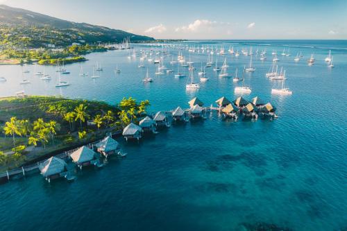 an aerial view of a harbor with boats and sailboats at InterContinental Tahiti Resort & Spa, an IHG Hotel in Faaa