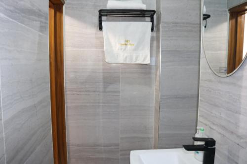a bathroom with a sink and a towel hanging on a wall at Excellent 2 bed apartment in Lekki Phase1 With SuperFast Wi-fi & 247 Power in Lekki