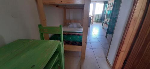 a small room with a bed and a wooden table at Atlantic Sal Hostel in Santa Maria