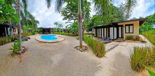 a resort with a swimming pool and a building at Beach Walk Costa Rica in Playa Avellana