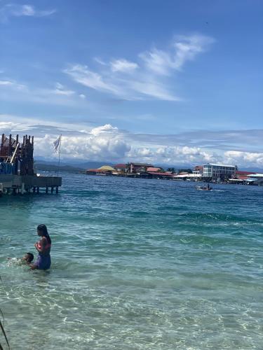 a woman and a child in the water at Jungle Bluff Beach Paradise - Jungle House in Bocas del Toro
