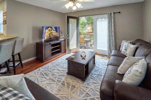 a living room with a couch and a table at Log Bunk Bed, Playhouse, & TeePee-Willow Trace Retreat 5mi to Dollywood in Sevierville