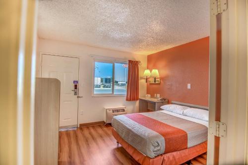a hotel room with a bed and a window at Motel 6-Stockton, CA - Charter Way West in Stockton