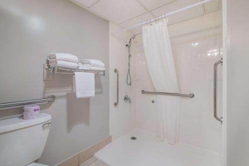 a white bathroom with a shower and a toilet at Best Western Saranac Lake in Saranac Lake