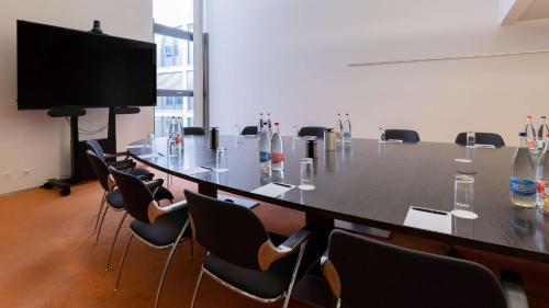 a large conference room with a long table and chairs at Radisson Blu Hotel, Lucerne in Luzern
