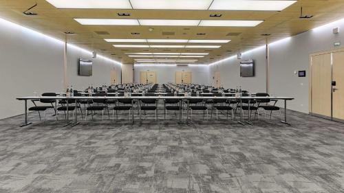 a large room with tables and chairs in it at Radisson Blu Hotel, Lucerne in Luzern