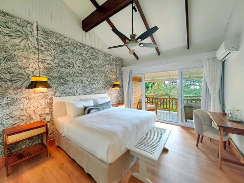 a bedroom with a large bed and a large window at Monteverde Lodge & Gardens in Monteverde Costa Rica