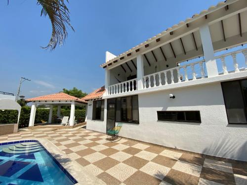 a villa with a swimming pool and a house at CASA ABEDULES 14 CONDOMINIO RESIDENCIAL SAN MARCOS POBLADO in Ricaurte