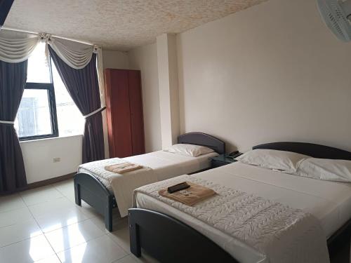 Postel nebo postele na pokoji v ubytování Hotel Quezada Hermanos